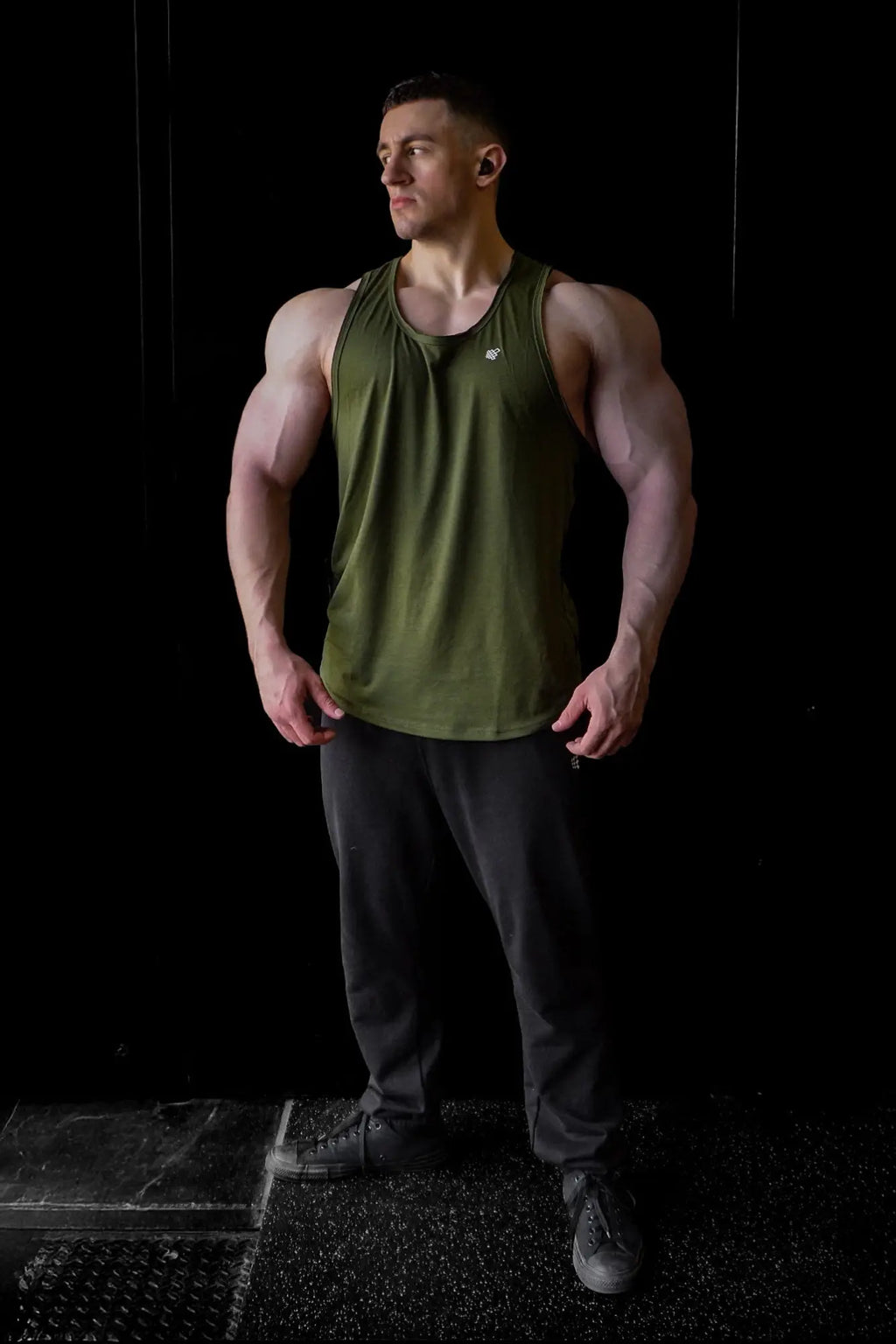Olive green sleeveless athletic tank top made of breathable fabric with raw hem for workout and casual wear by Jed North