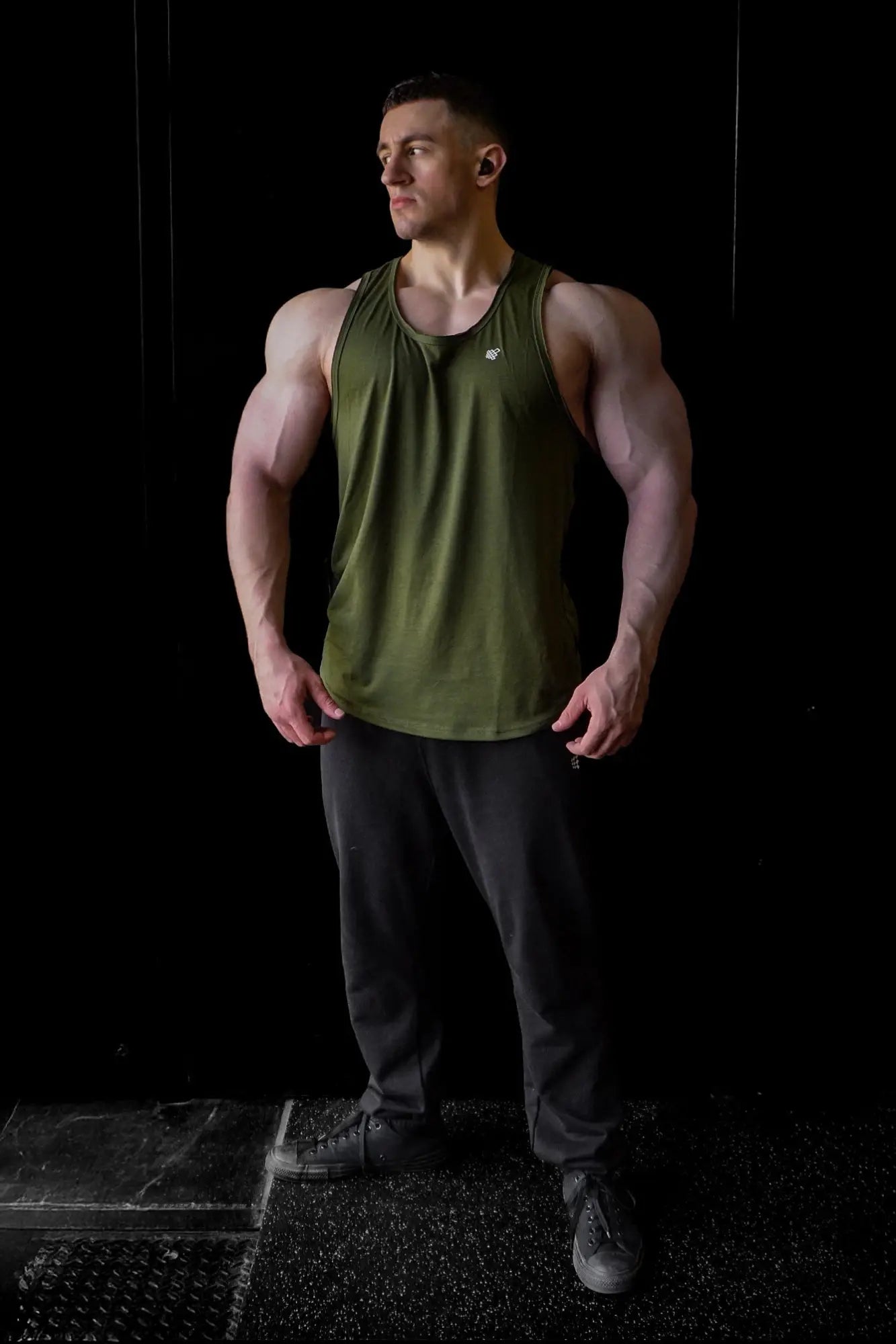 Olive green sleeveless athletic tank top made of breathable fabric with raw hem for workout and casual wear by Jed North