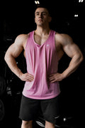 Pink athletic tank top by jed north with a small white logo on the chest in salmon pink raw-hem design