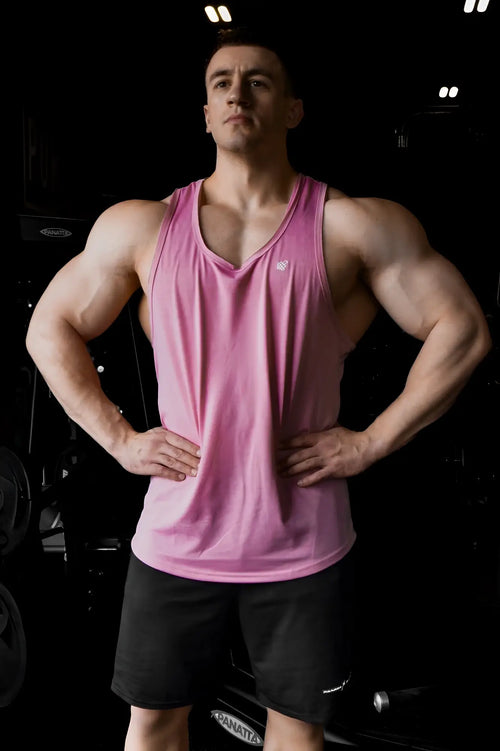 Pink athletic tank top by jed north with a small white logo on the chest in salmon pink raw-hem design
