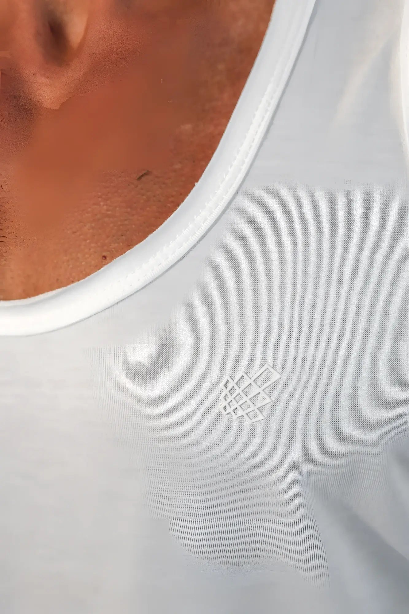 White embroidered logo on a light gray cotton vital raw-hem tank top 2.0 front side