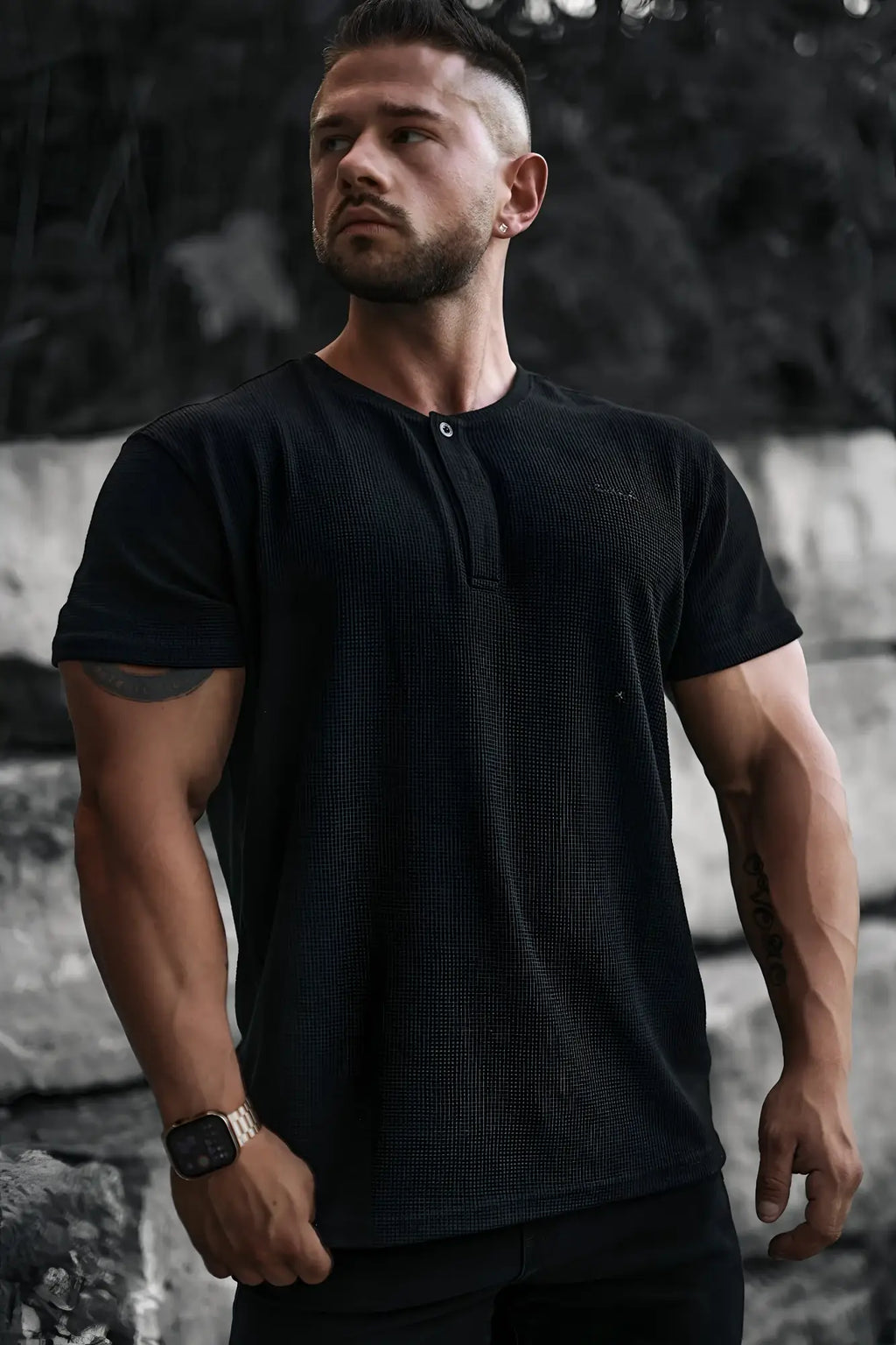 Black waffle henley t-shirt with a subtle ribbed texture short sleeves and single button neckline