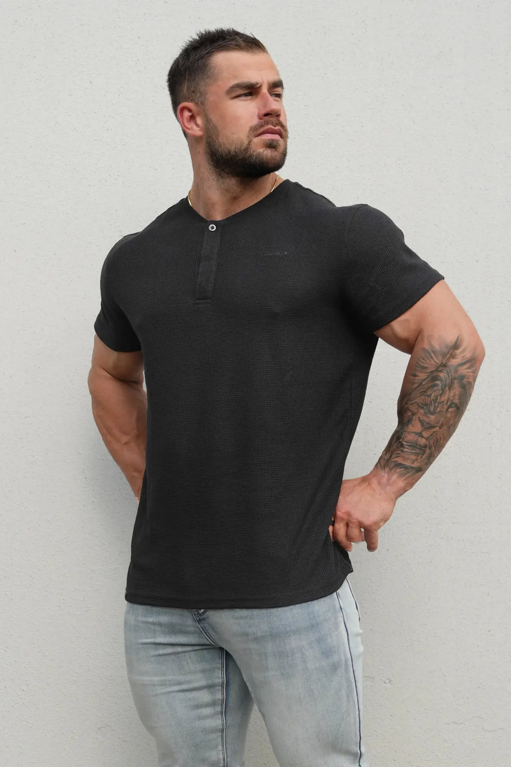 Black waffle henley t-shirt with textured fabric and single button neckline in short-sleeve style