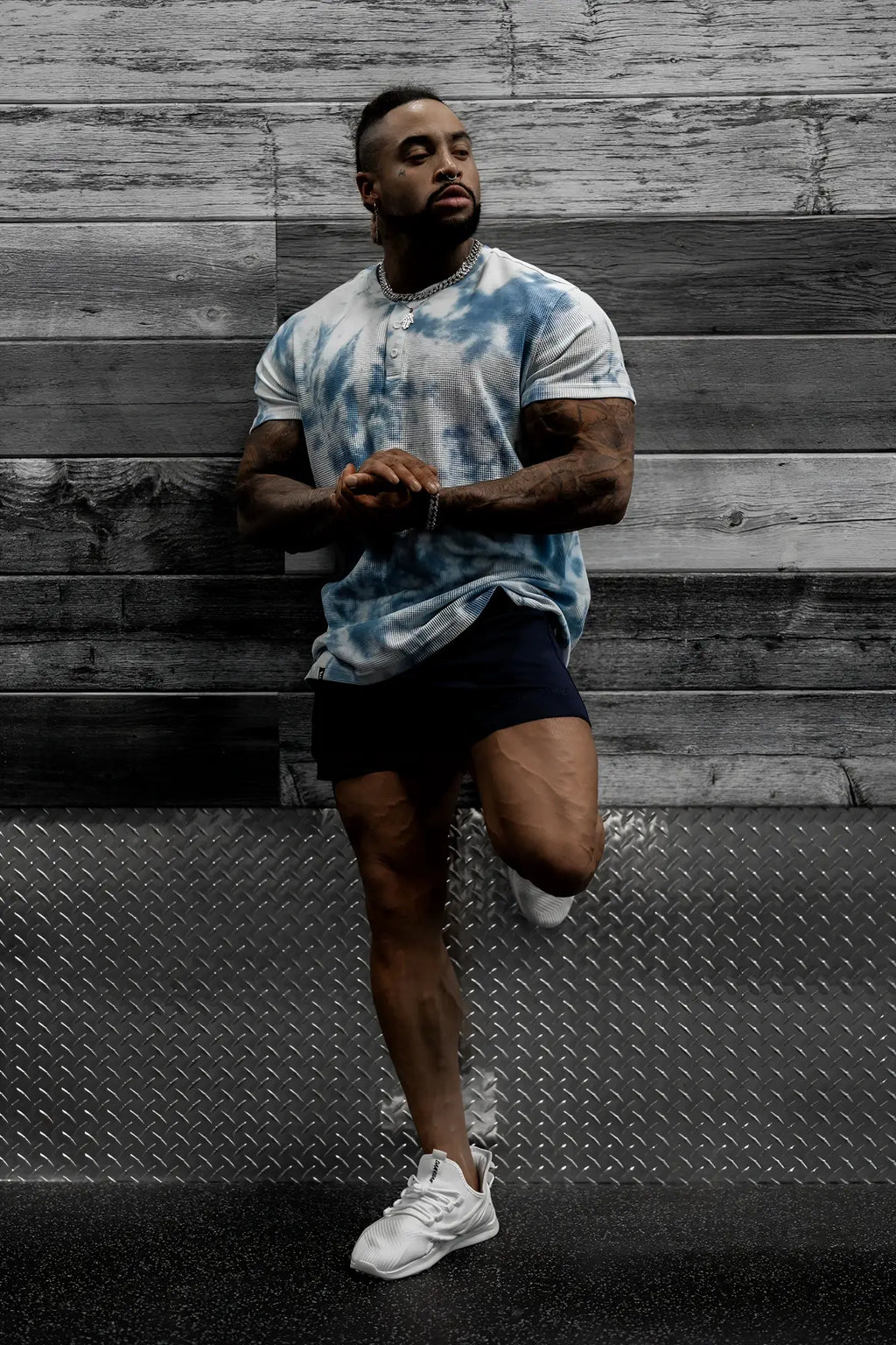 Man wearing a blue and white tie dye waffle henley t-shirt made of textured cotton for casual wear