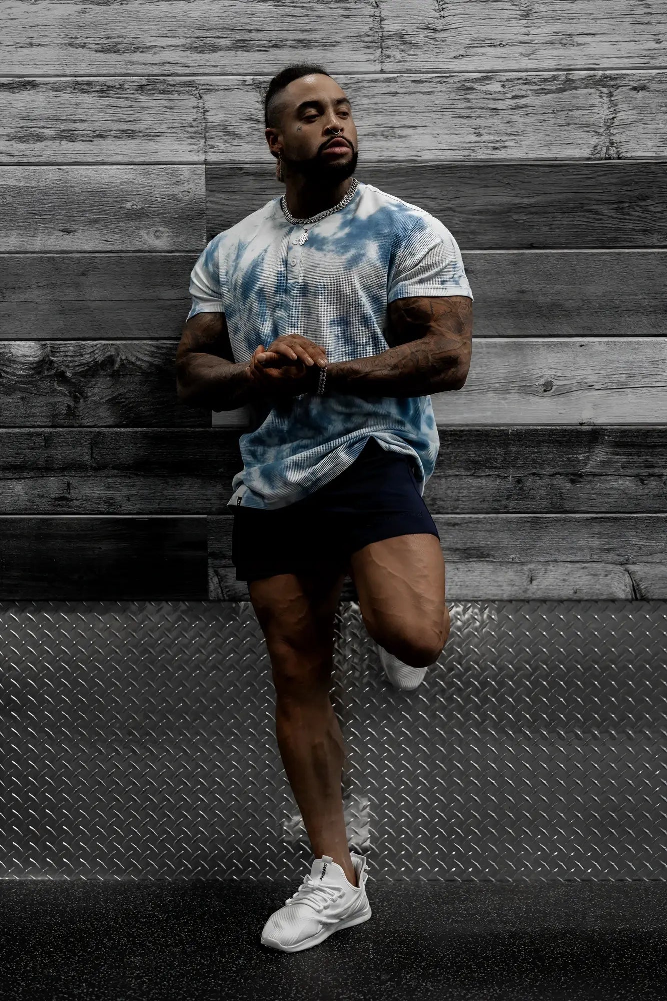 Man wearing a blue and white tie dye waffle henley t-shirt made of textured cotton for casual wear
