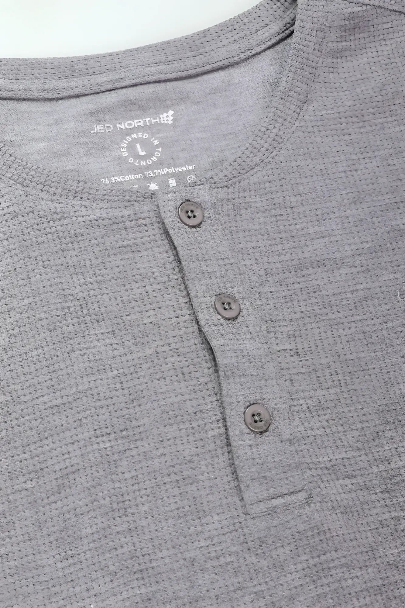 Light gray waffle henley t shirt with gray heathered fabric three dark gray buttons and ribbed collar
