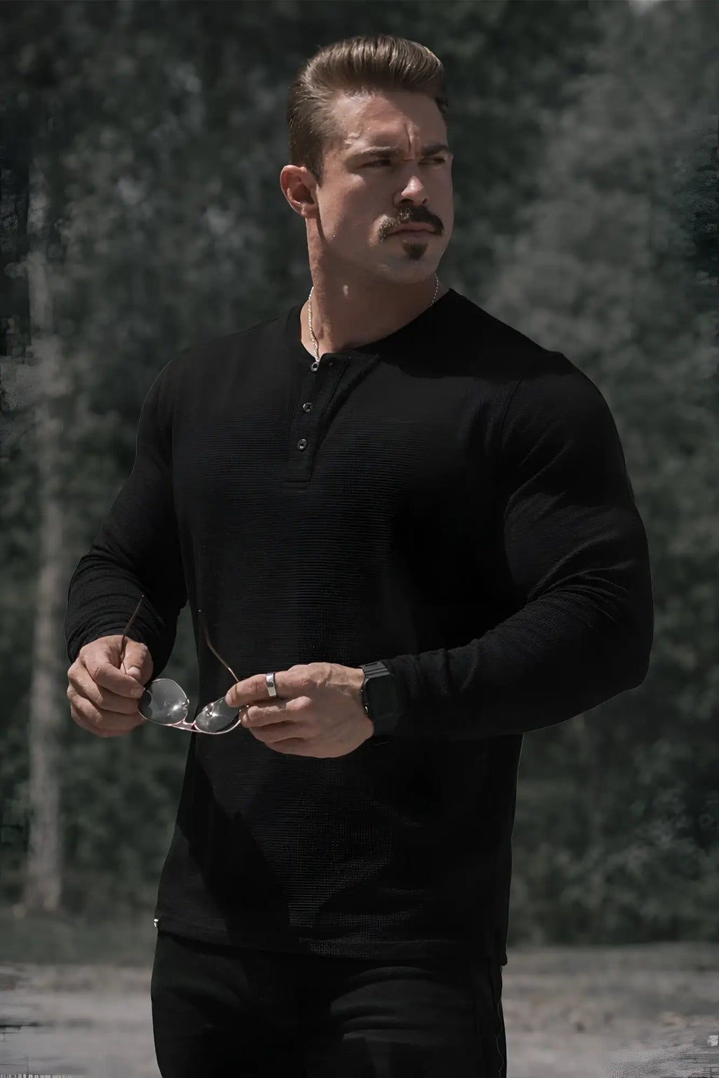 Black waffle knit henley long sleeve t-shirt with buttoned placket made of textured knit fabric