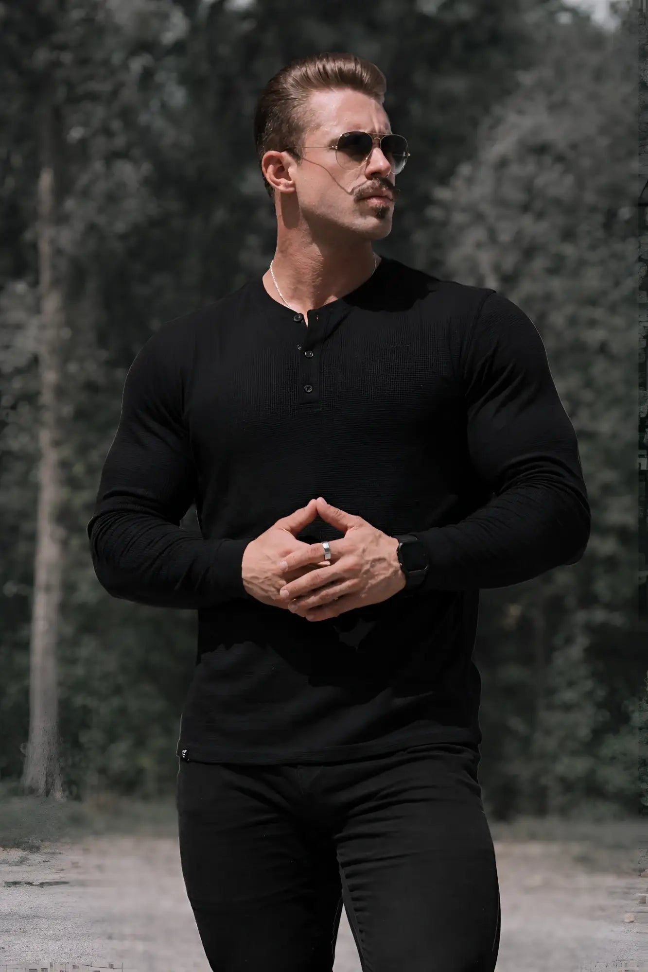 Black waffle knit henley long sleeve t-shirt with ribbed texture and three-button placket