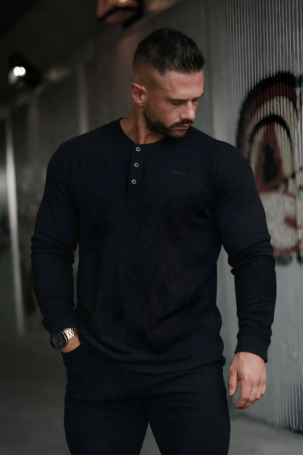 Black waffle knit henley long sleeve t-shirt with white button accents and long sleeves