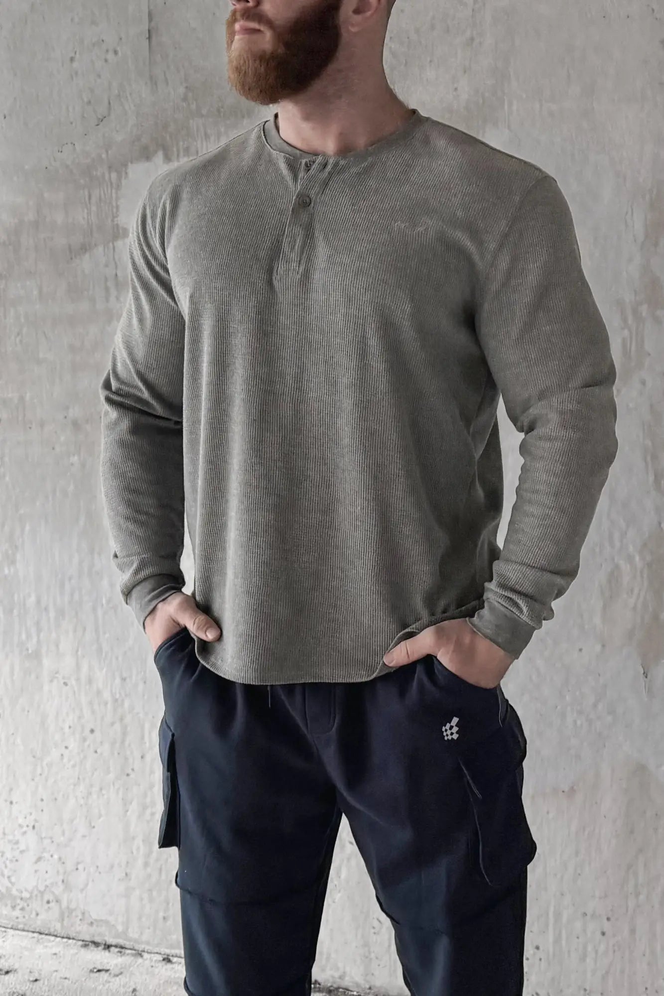Olive green waffle knit henley long sleeve t-shirt featuring a henley collar and soft knit material