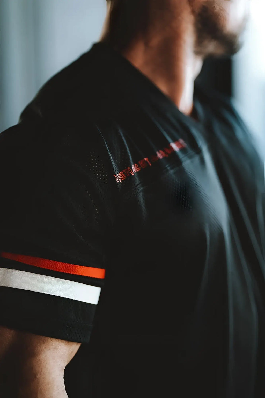 Black jed north warrior v-neck jersey with red and white striped sleeve cuffs and embroidered shoulder logo