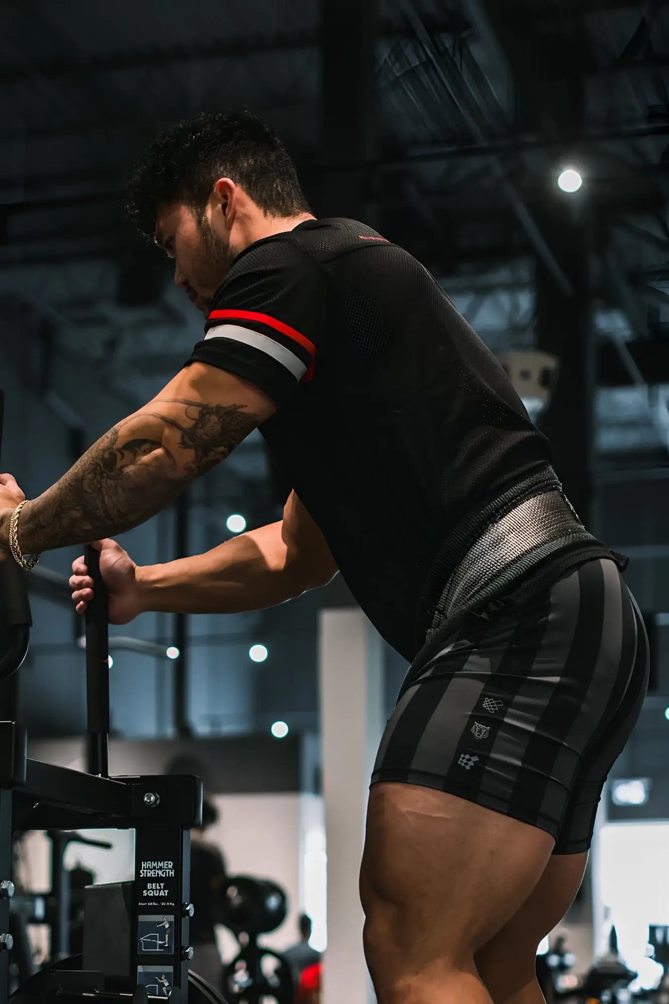 Black and gray striped athletic shorts with mesh waistband paired with jed north warrior v neck jersey black