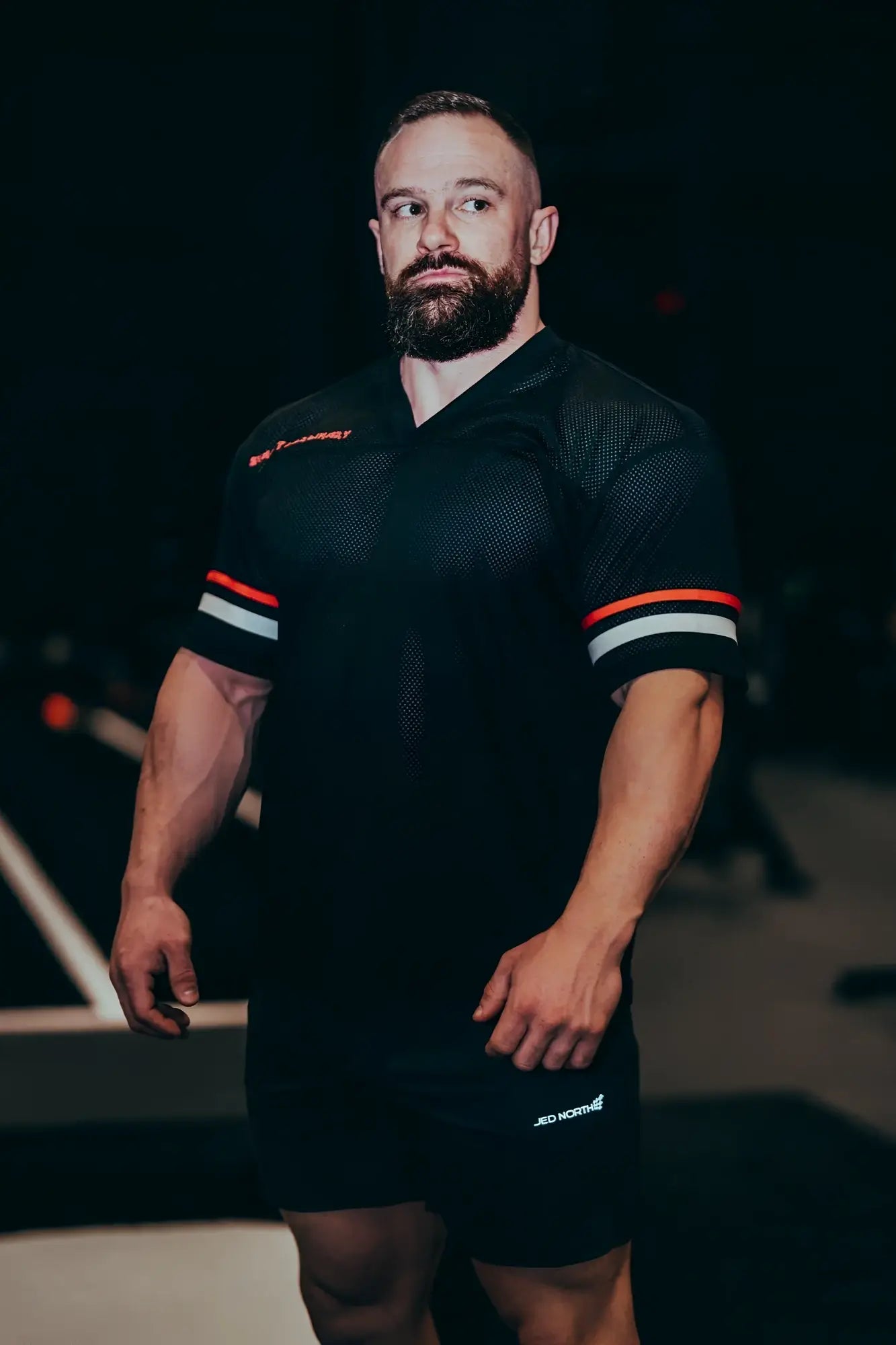 Black jed north warrior v-neck jersey with orange and white striped sleeves made of breathable mesh fabric