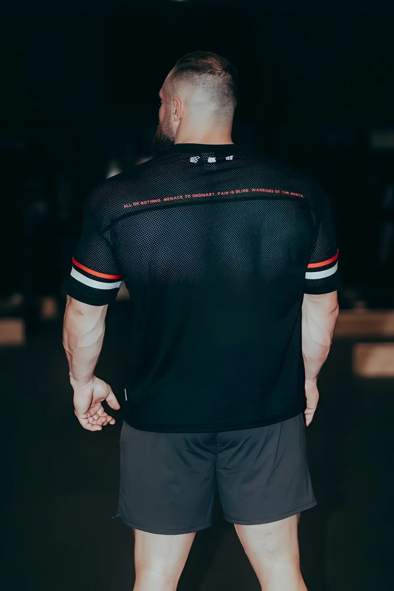 Black mesh jed north warrior v-neck jersey with red and white striped sleeves designed for athletic use