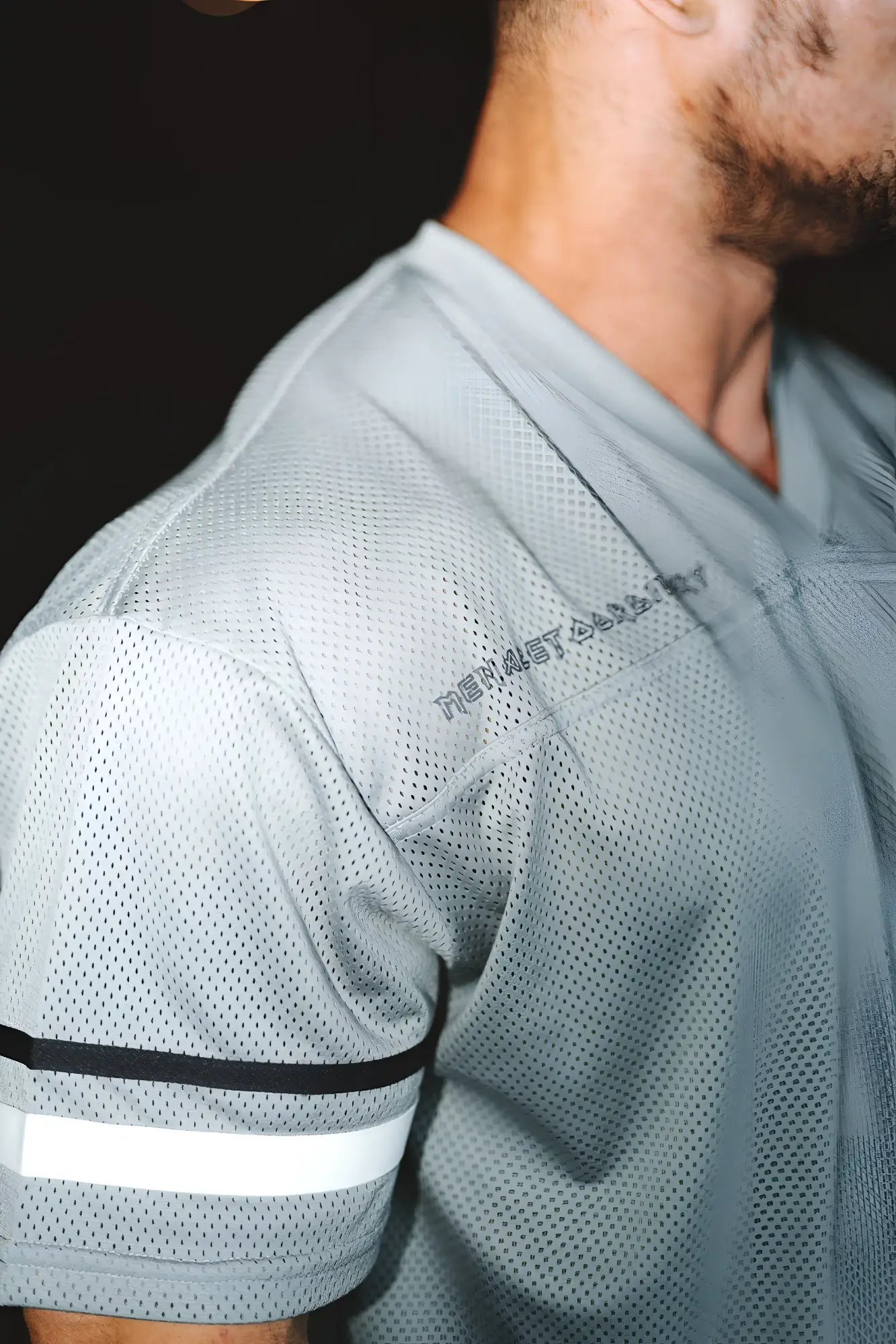 Light gray mesh jed north warrior v neck jersey with black and white striped sleeve accents for athletic use