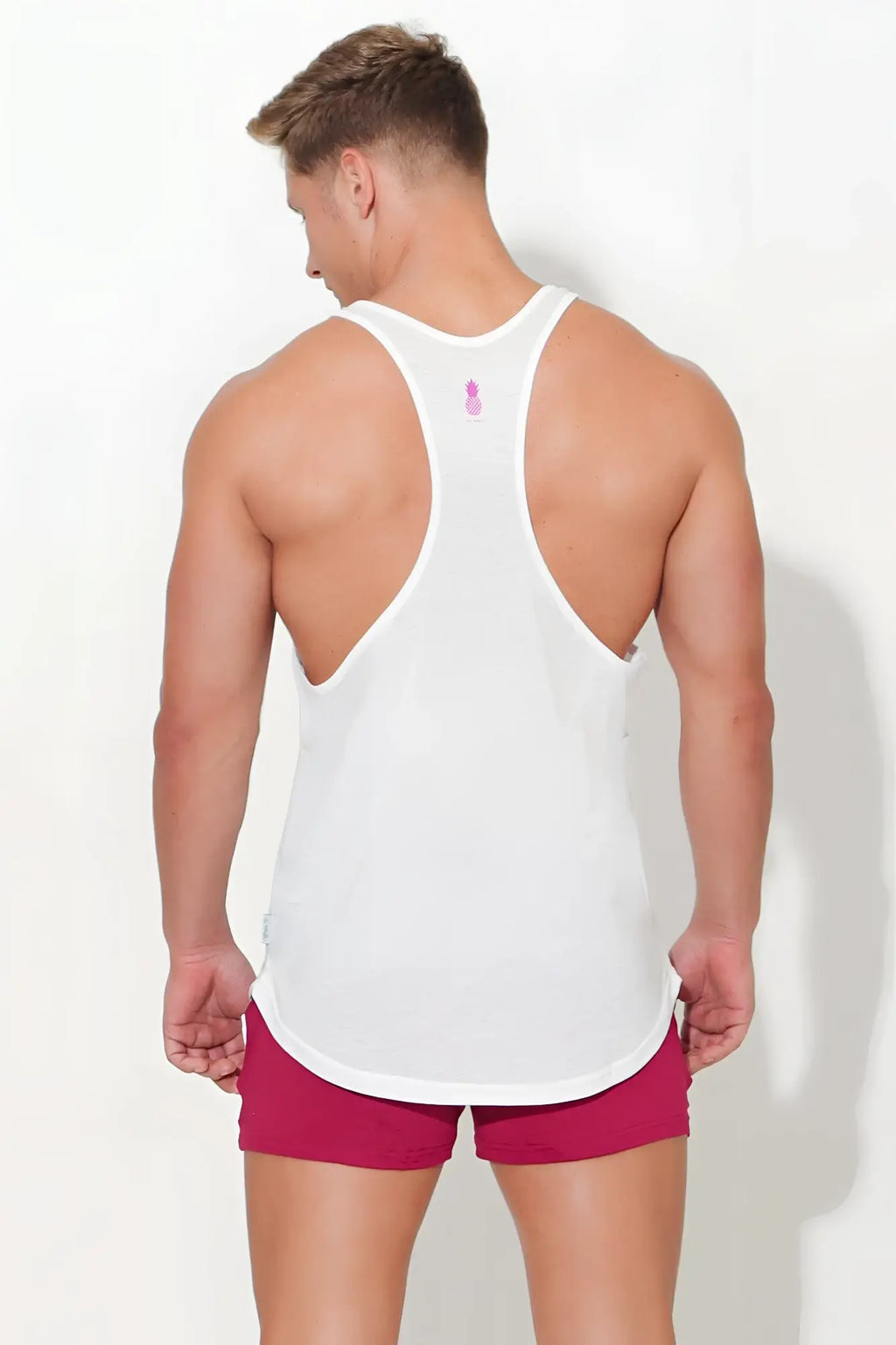 Back view of jj classic workout stringer white tank top with pink logo and racerback design for exercise