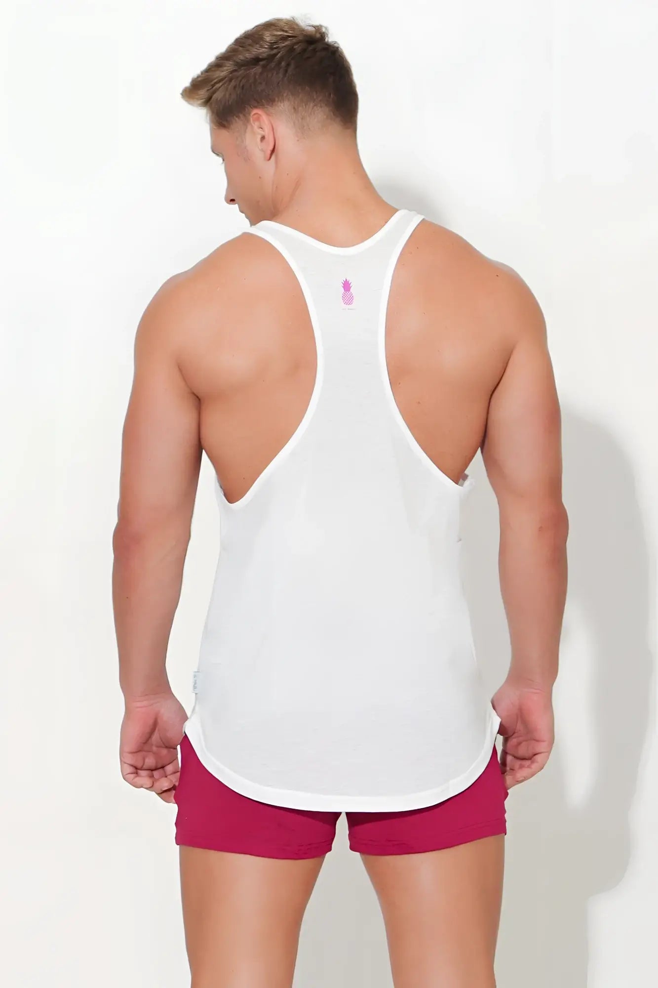 Back view of jj classic workout stringer white tank top with pink logo and racerback design for exercise