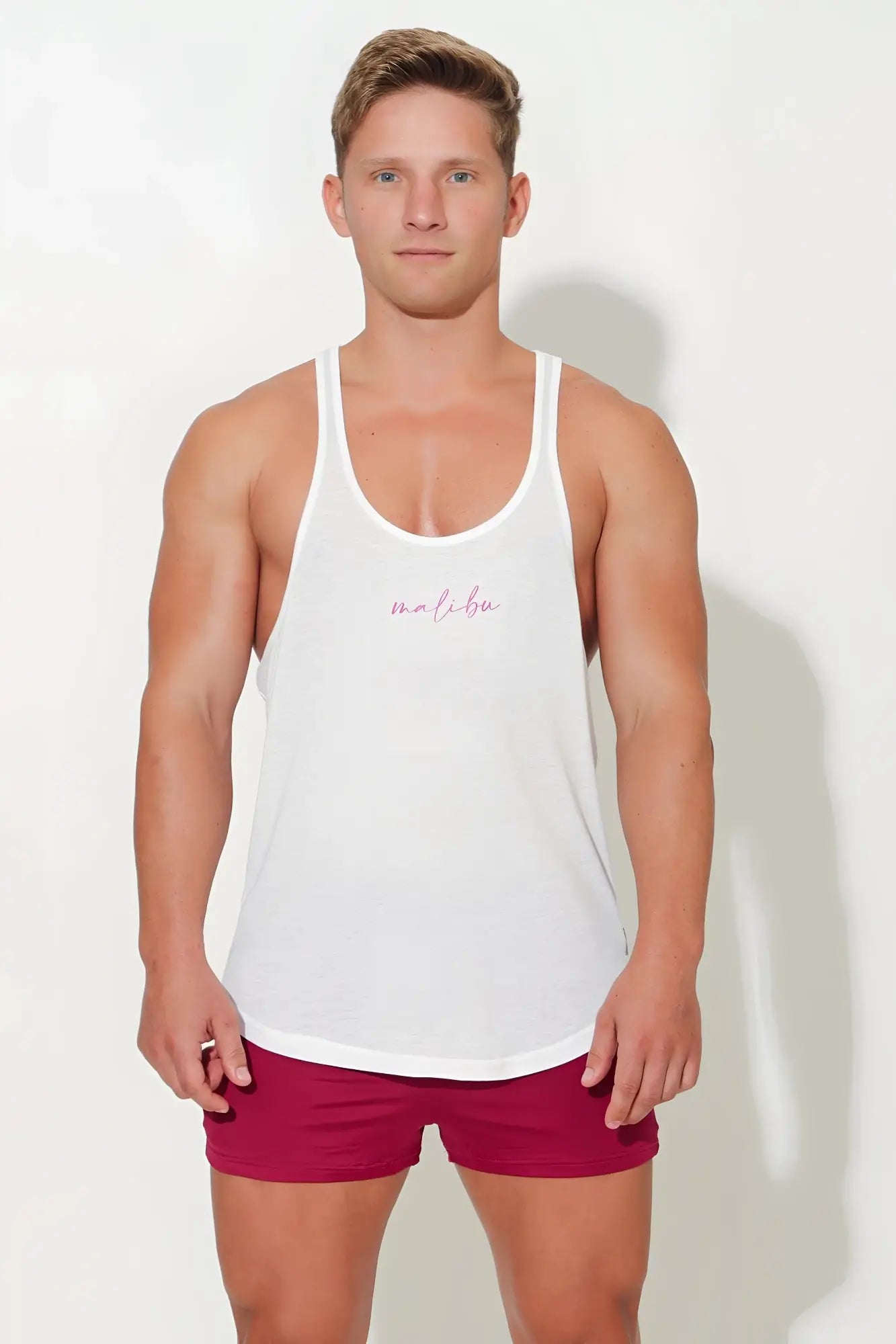White jj classic workout stringer tank top with subtle pink cursive logo across the chest