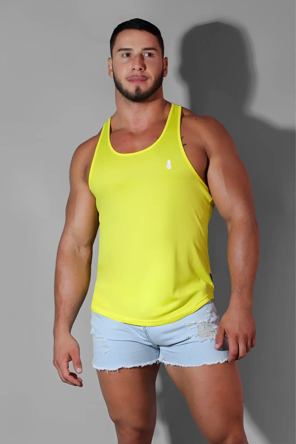 Bright yellow sleeveless jj cool-dry gym stringer tank top with a small white logo on the chest for workouts