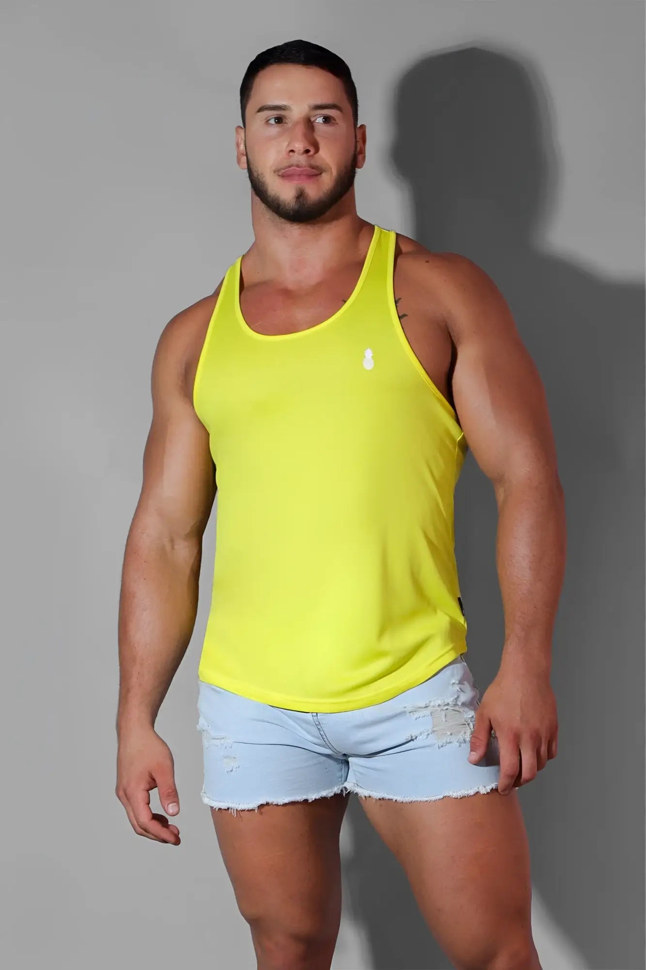 Bright yellow sleeveless jj cool-dry gym stringer tank top with a small white logo on the chest for workouts