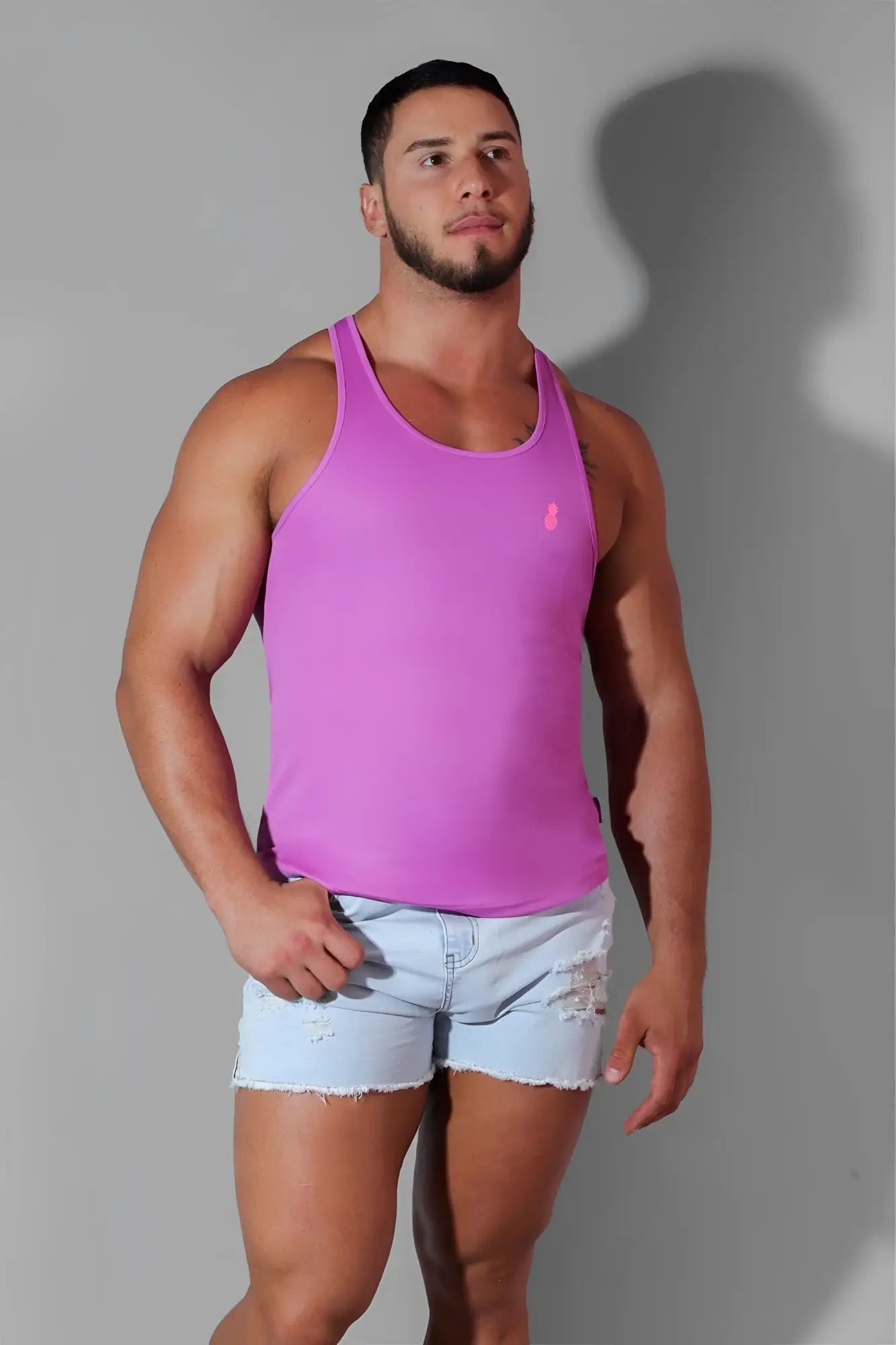 A vibrant pink neon purple jj cool dry gym stringer sleeveless tank top with small embroidered logo on the chest