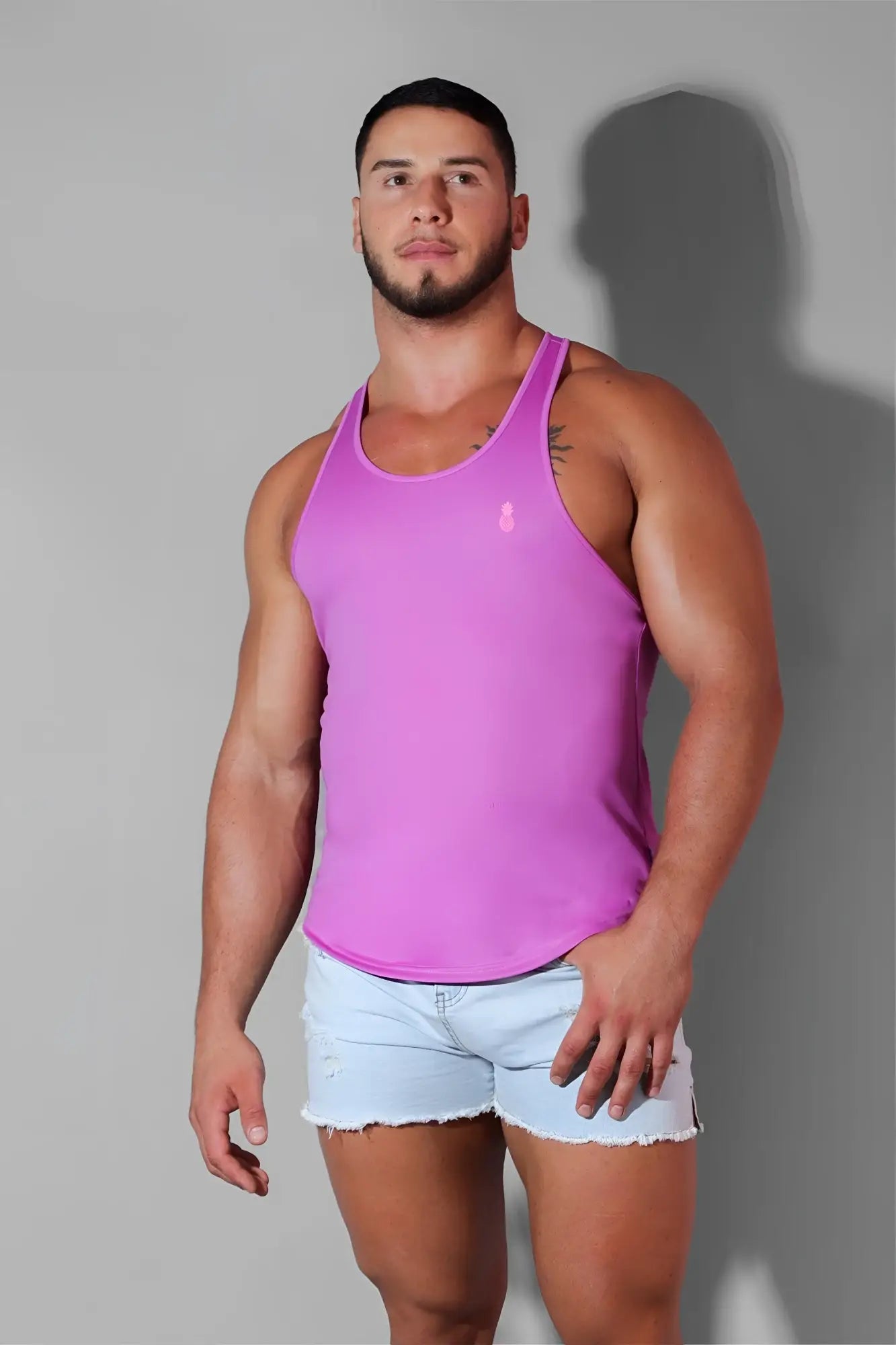 A vibrant neon purple sleeveless jj cool-dry gym stringer tank top with a small embroidered logo on the chest