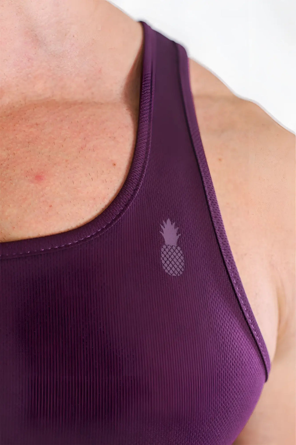 Purple jj dry-cool crop tank top featuring a subtle pineapple logo on the shoulder strap for athletic use