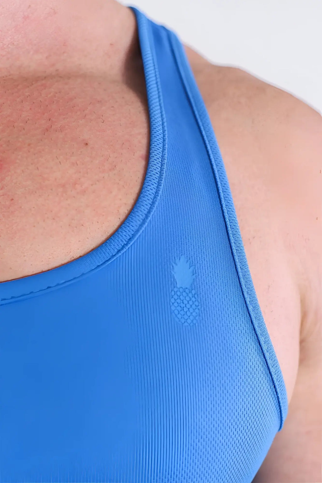 Bright blue breathable mesh JJ Dry-Cool Crop Tank Top with subtle pineapple logo embroidered on the chest