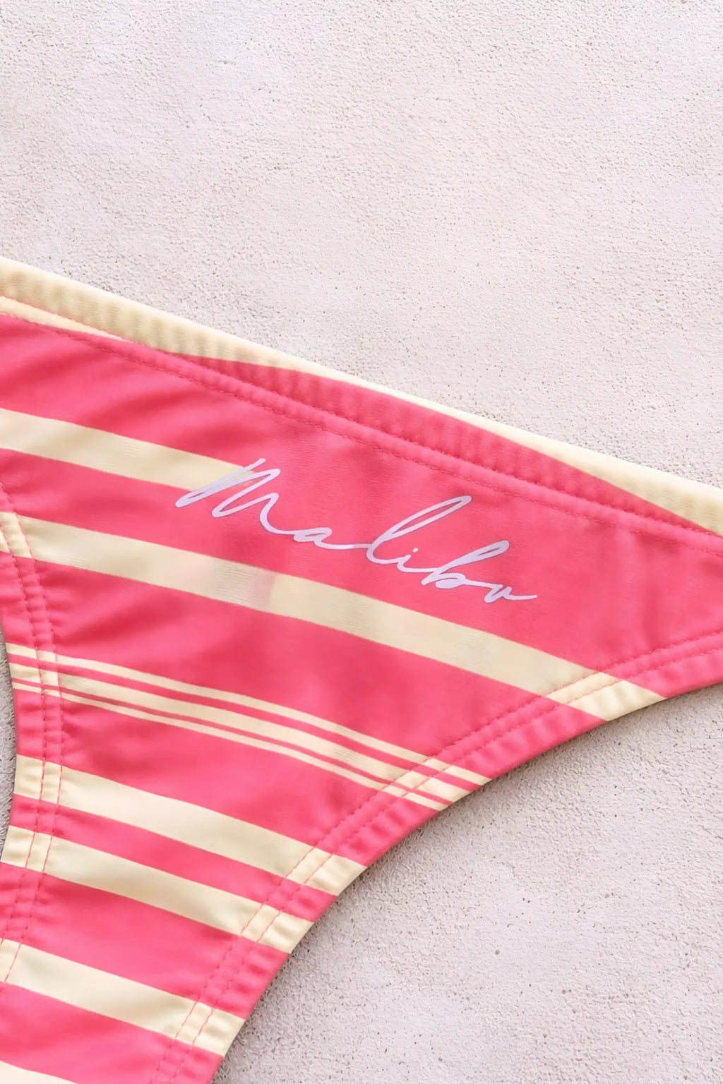Cheeky classic g-string thong in pink and cream stripes with malibu embroidery visible on the back side