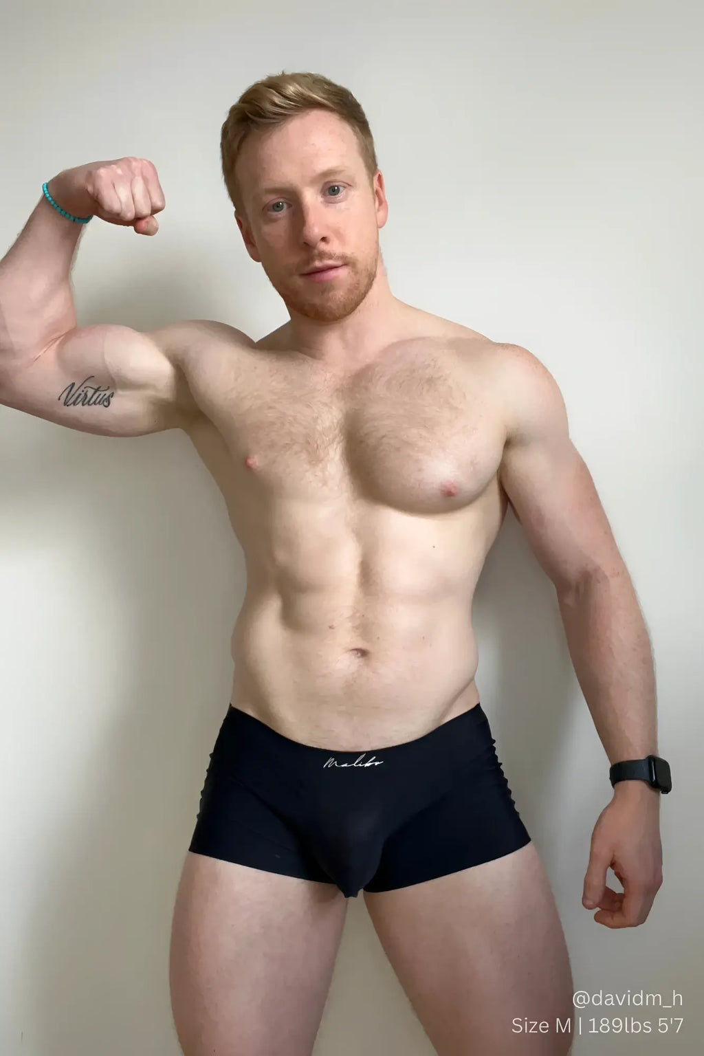 Black silky seamless boxer briefs with subtle white embroidered logo on waistband in midnight black color
