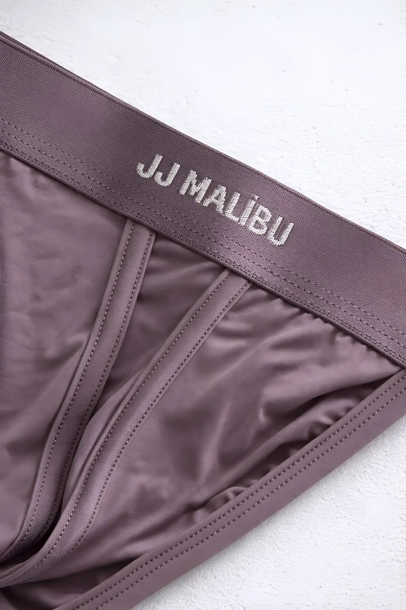 On display jockstrap in taupe with smooth satin fabric and stitched waistband shown from the back side