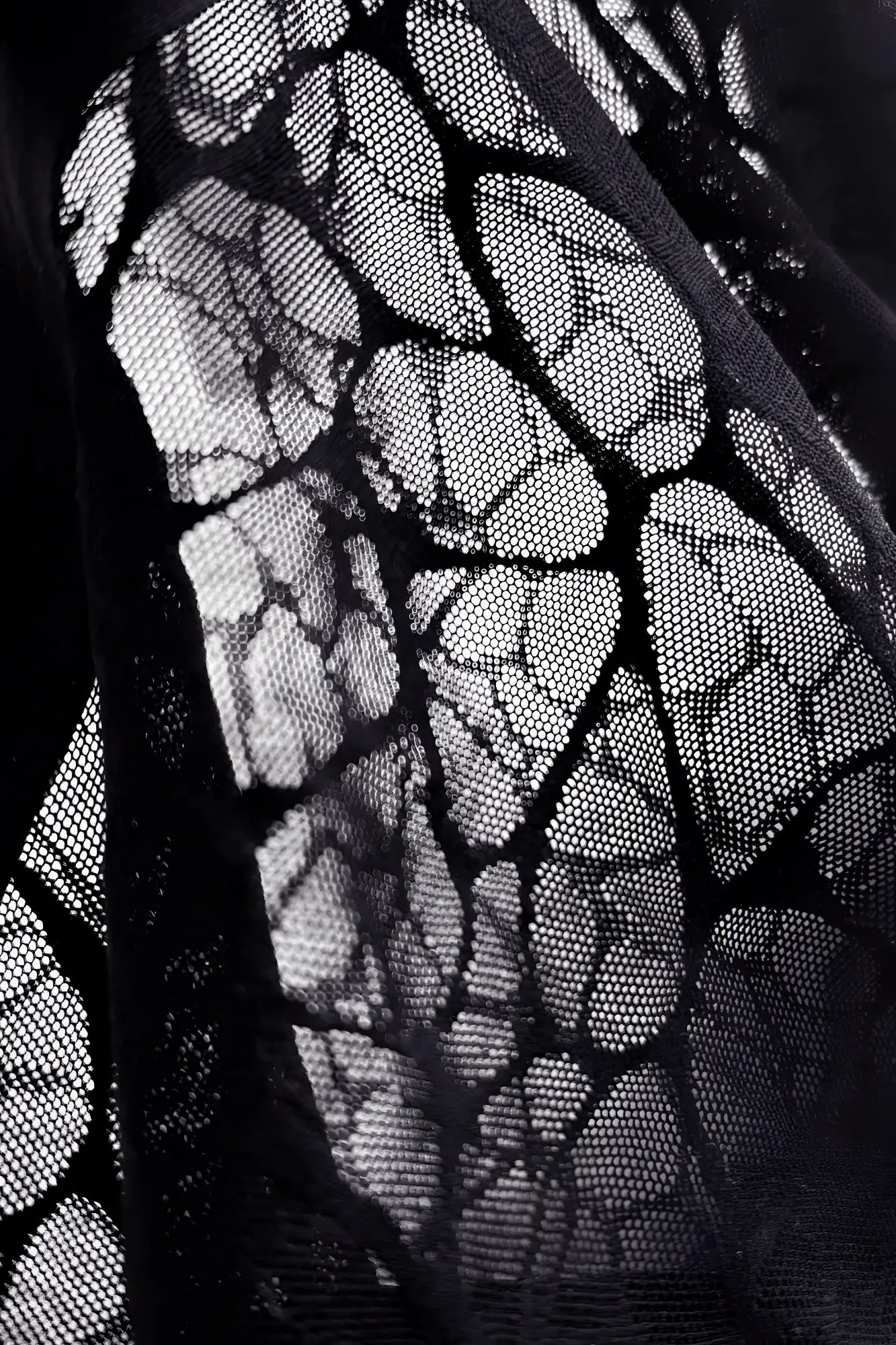 Charcoal black geo-mesh seamless boxers made of black lace fabric with delicate leaf-like pattern and fine mesh texture