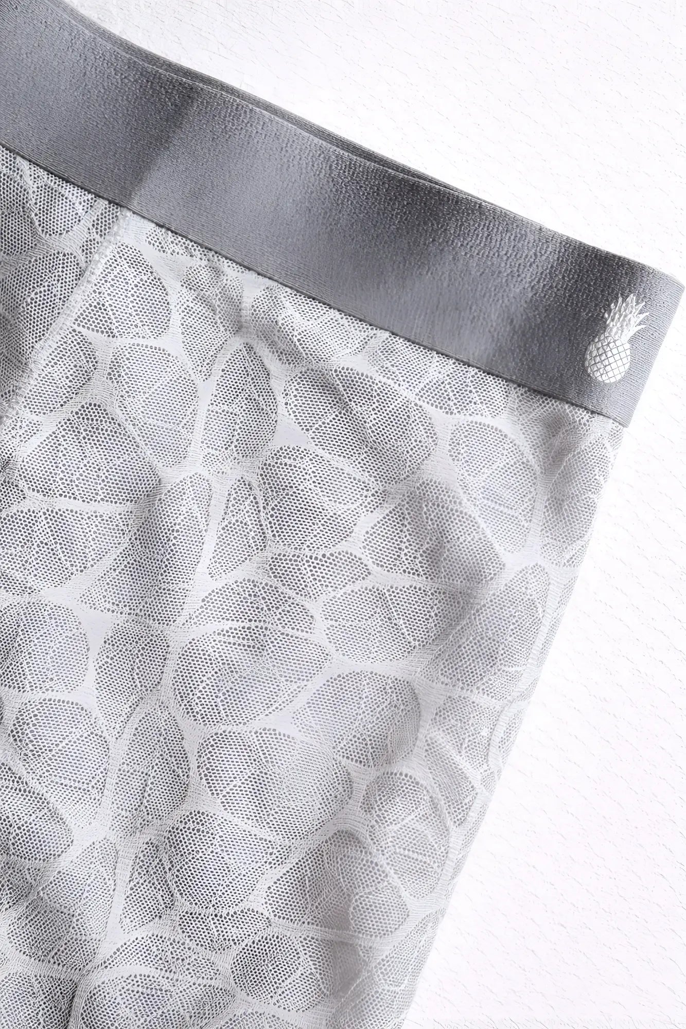 Gray geo-mesh seamless boxers with subtle pineapple embroidery on the elastic waistband in storm grey color