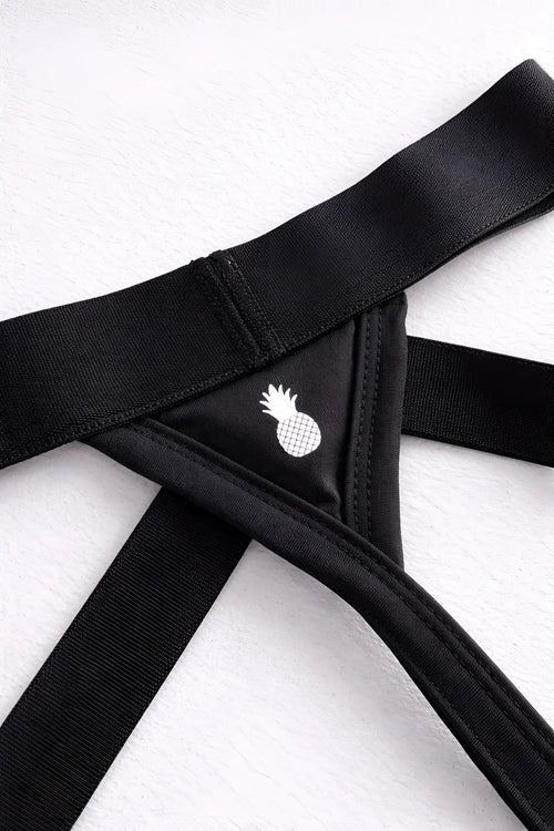 Host-or-travel adjustable jock thong in midnight black with black elastic bandeau and white pineapple emblem