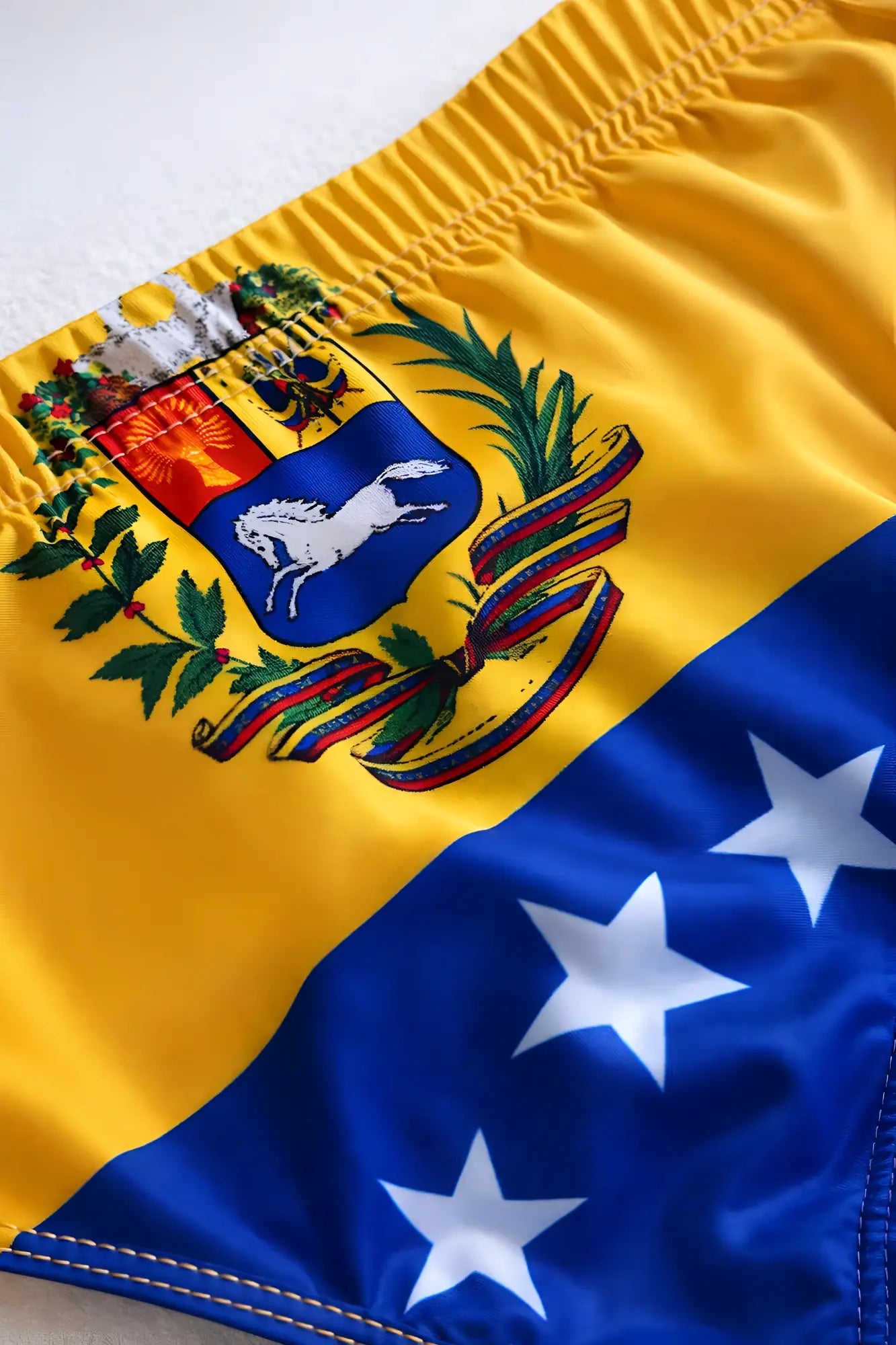 Lovesick briefs yellow and blue swim trunks with venezuela flag coat of arms featuring white horse red sun and stars