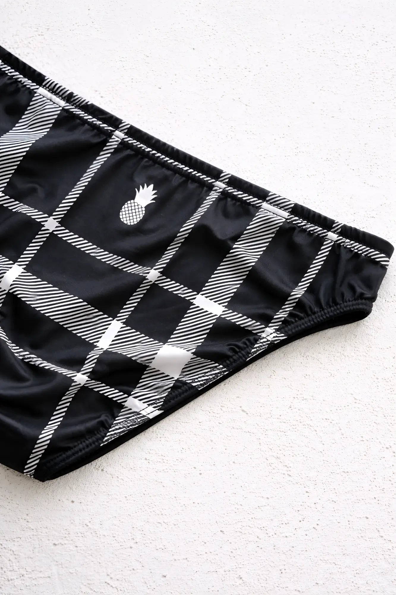 Men’s slimmer bulge briefs og plaid in black and white plaid with a small pineapple emblem on the side