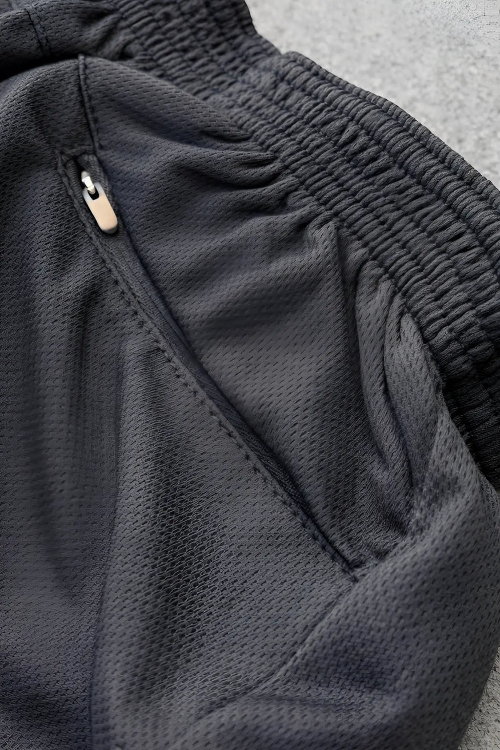 Dark gray mesh stretch-it 2 quick-dry athletic shorts with ribbed elastic waistband and zipper pocket in midnight black