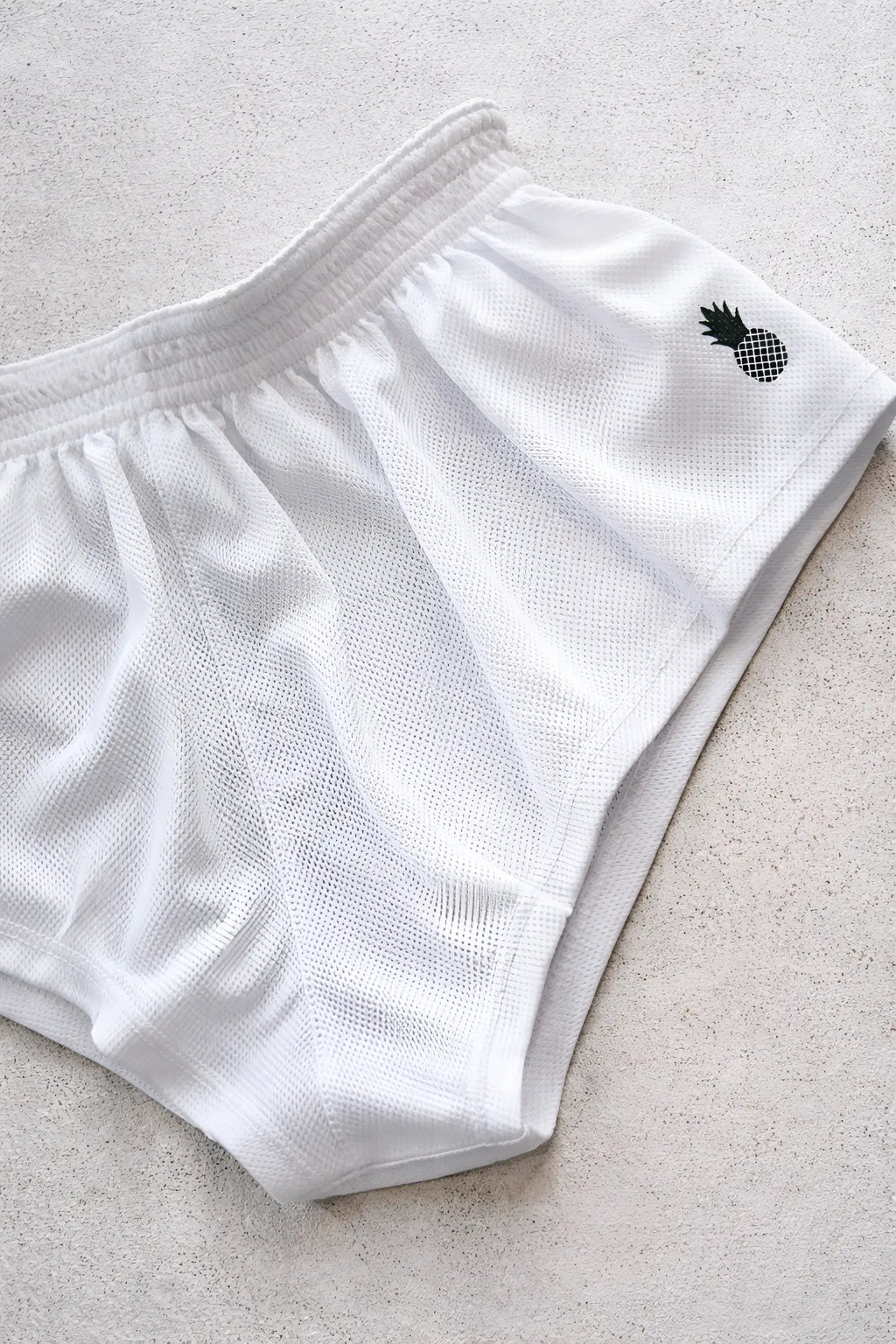 White mesh stretch-it 2 quick-dry athletic shorts with black pineapple logo embroidered on the side