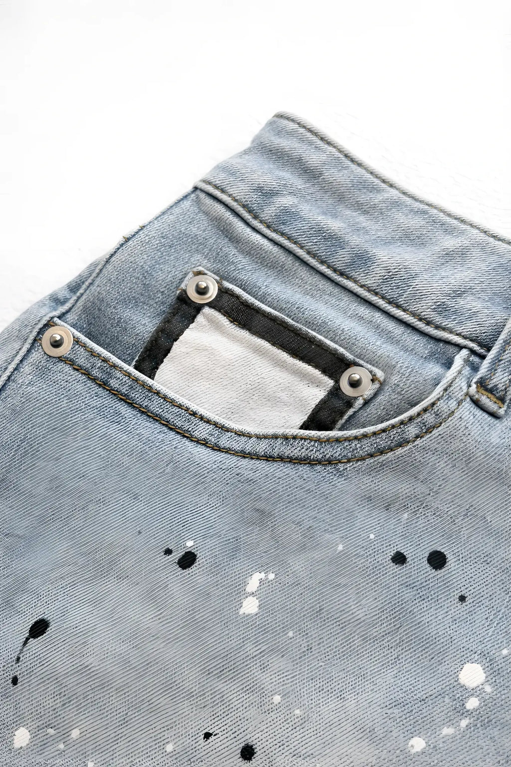 Studio splash 1.5 inch light-wash denim short shorts in sky blue with distressed pocket silver rivets and paint splatter details