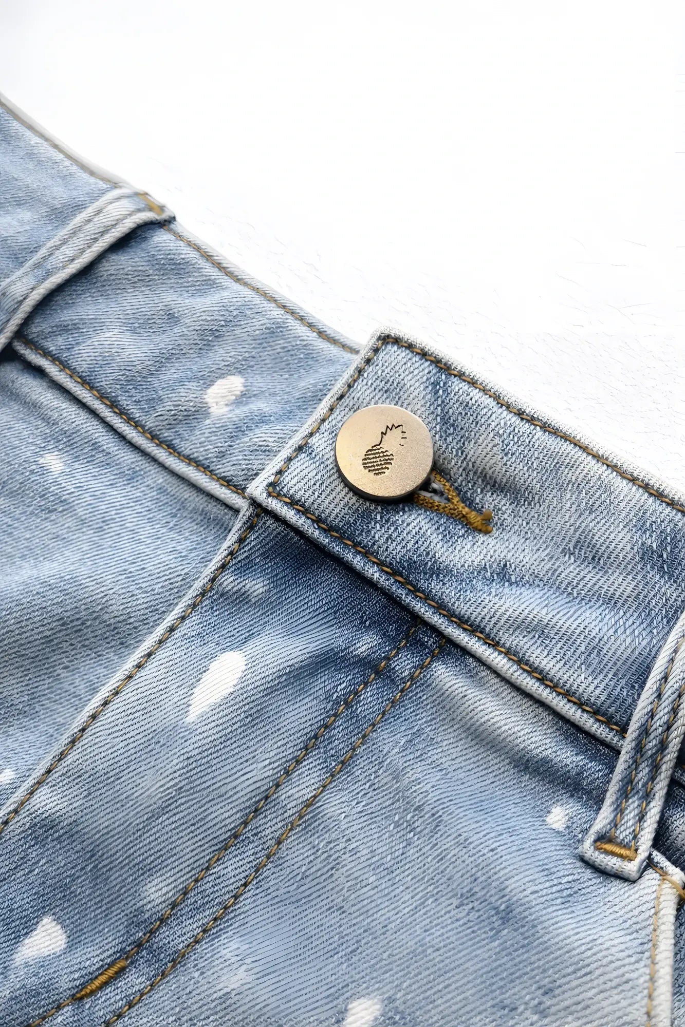 Studio splash 1.5 inch light-wash denim short shorts in sky blue with distressed splattered white paint and metallic logo button