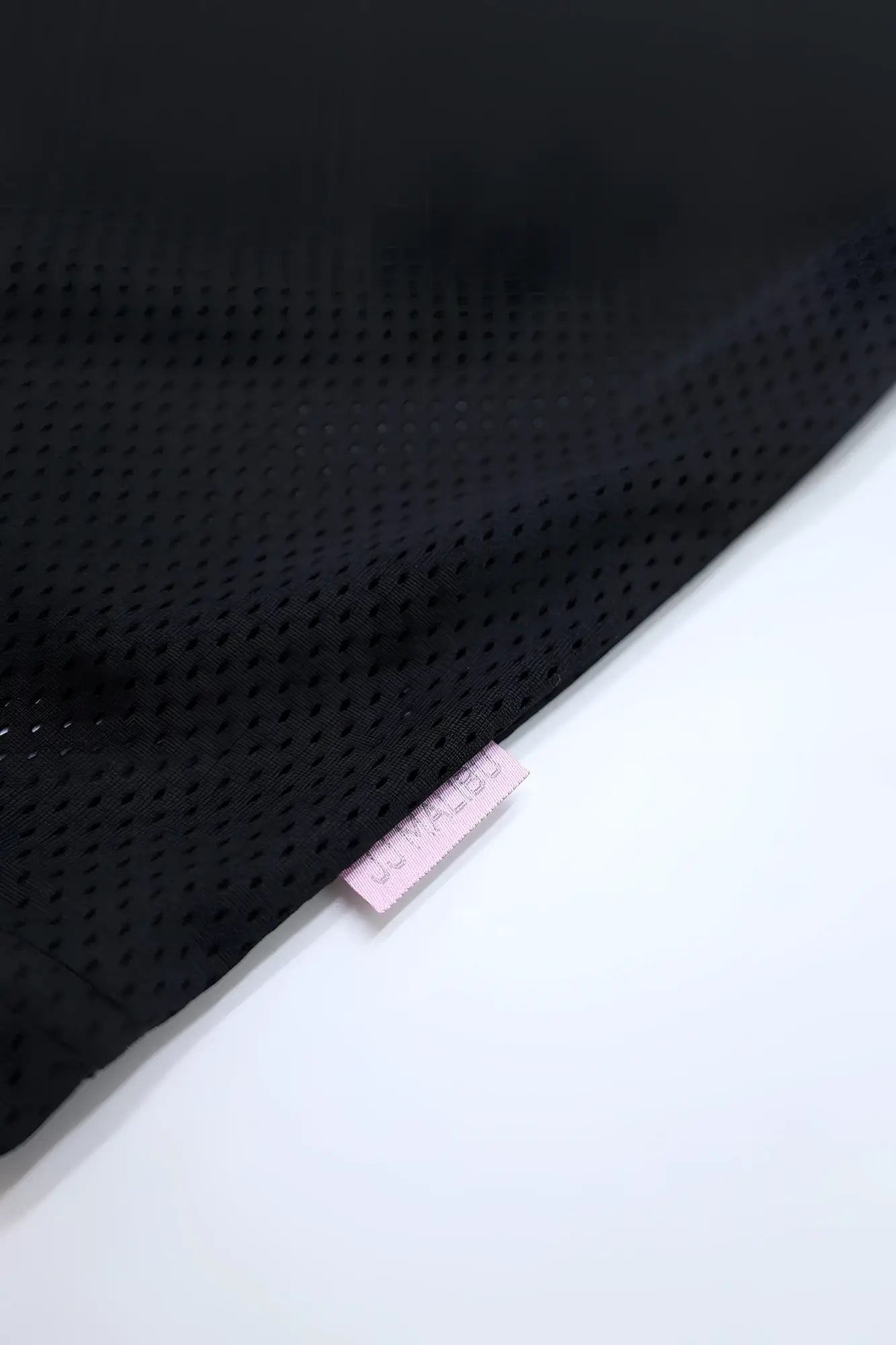 Jj varsity v-neck jersey black showing black perforated mesh fabric with a small pink tag detail