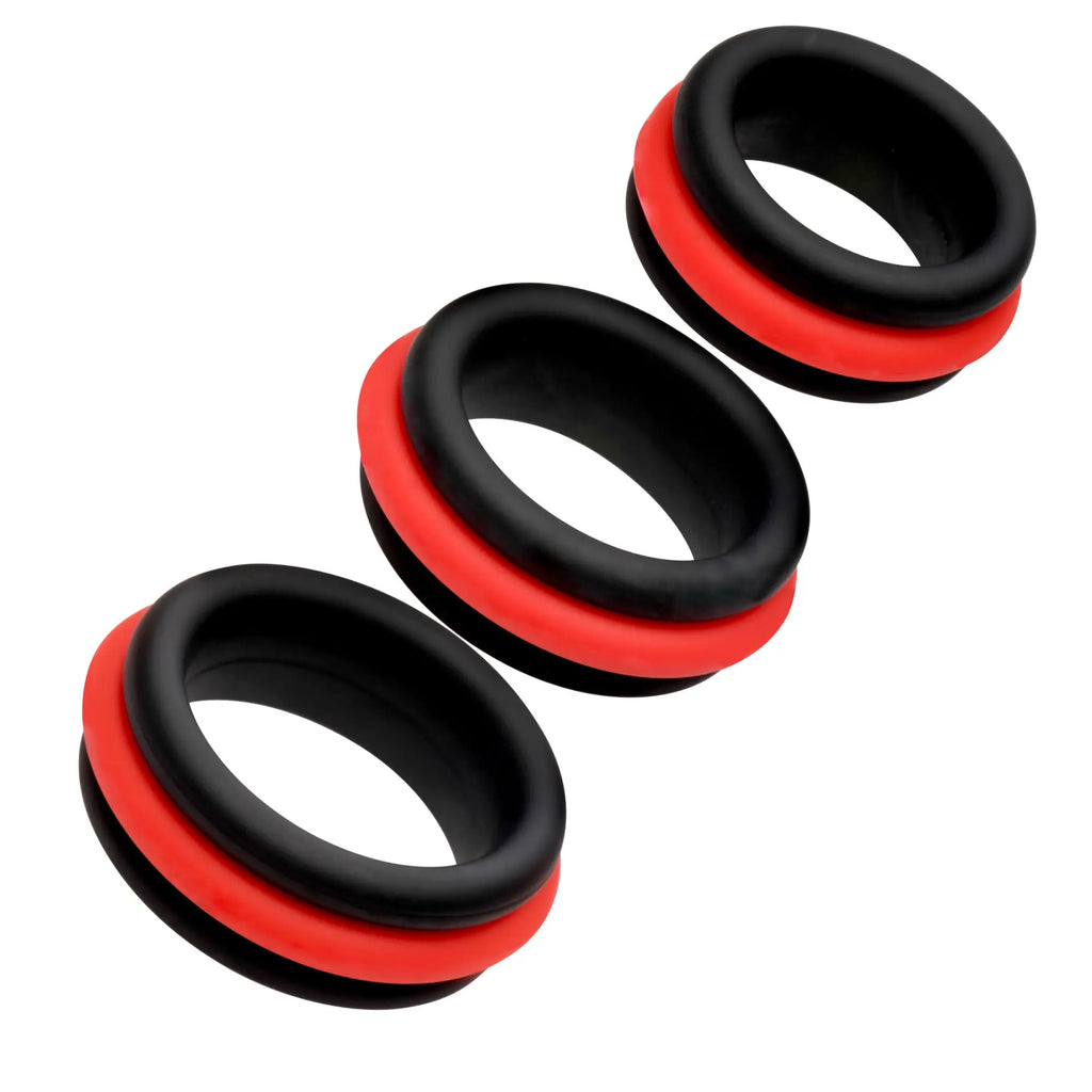 Jock 3pc Enhancers: Three black and red 2-in-1 silicone cock rings arranged diagonally against a white background.