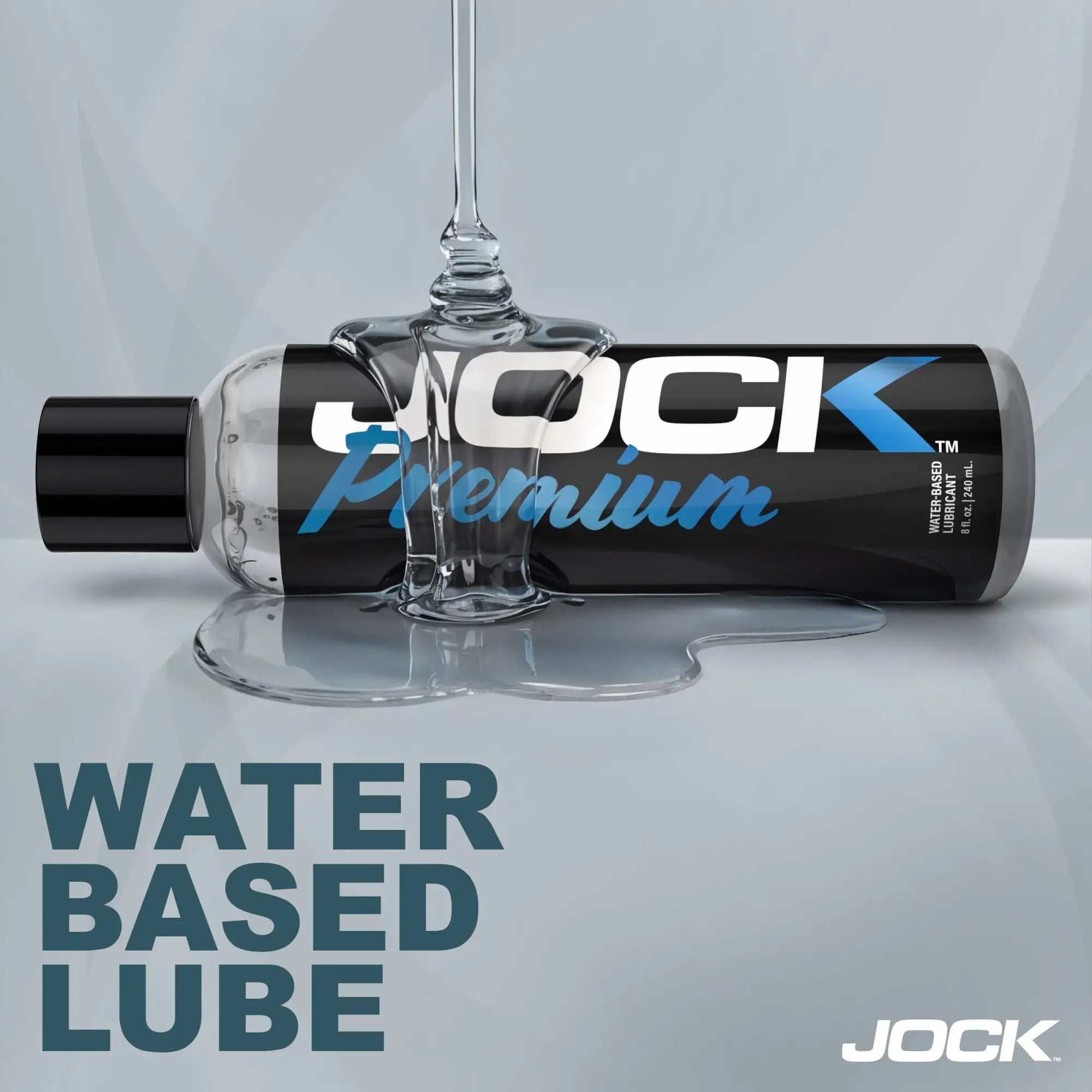 Jock 8oz Premium Water Based Lubricant bottle lying down with clear lubricant pouring over the label against grey.