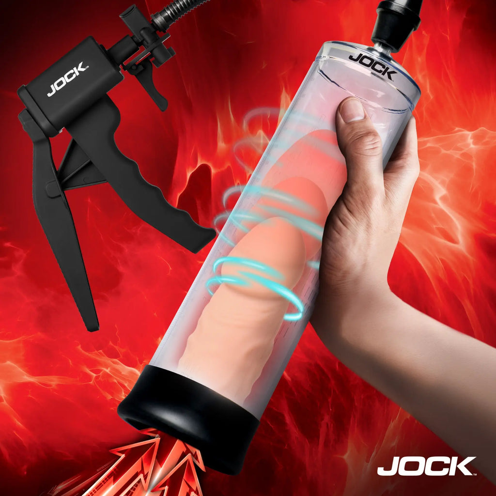 Jock Amp Up penis pump with clear cylinder, black trigger handle, and a hand holding the device against a red background.