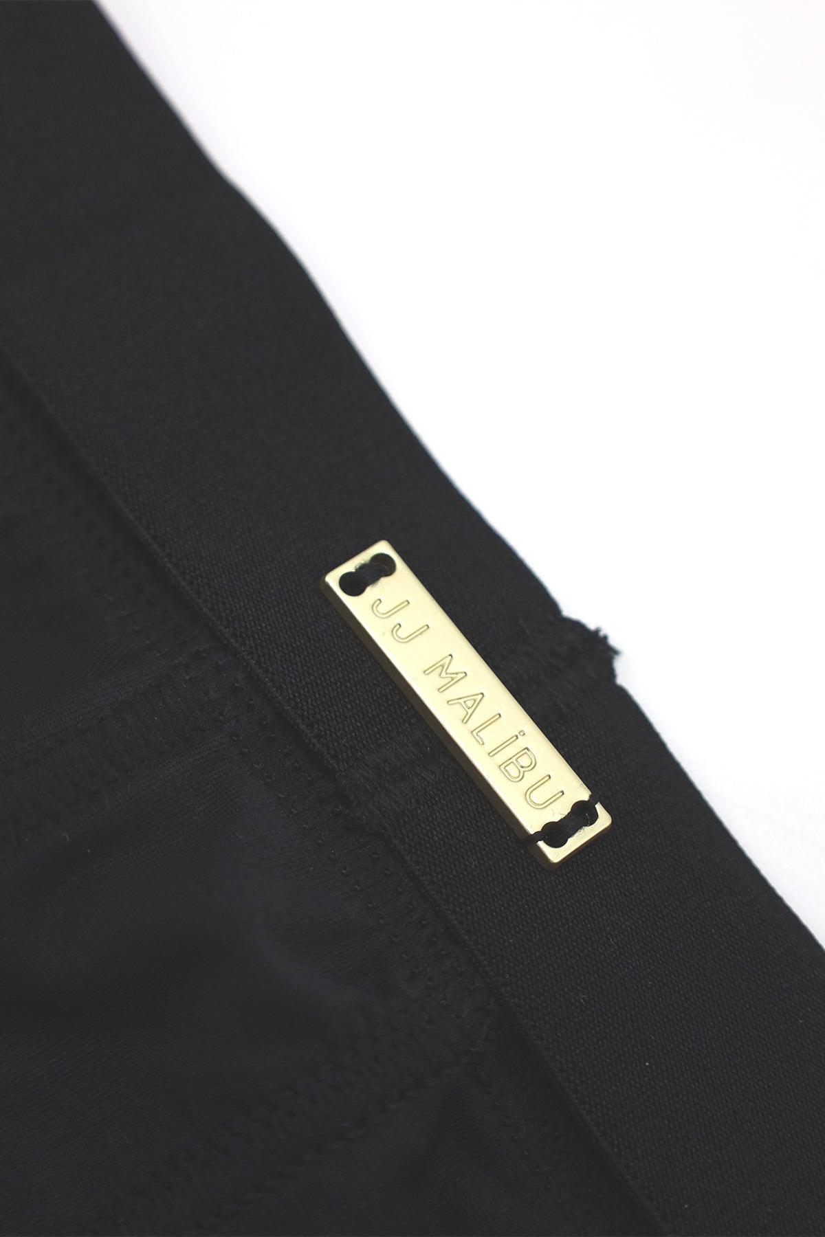 Black on-display jockstrap featuring a gold-tone rectangular jj malibu label on soft fabric