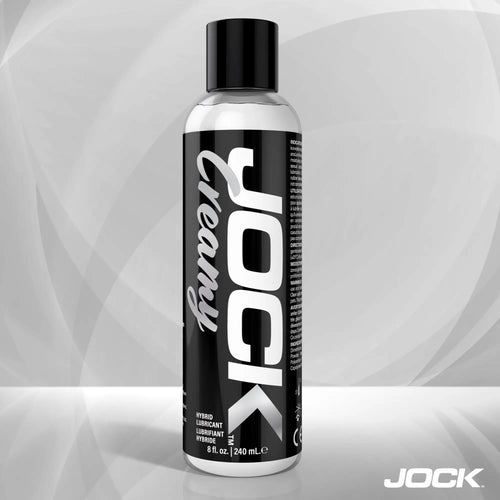 8oz bottle of JOCK Creamy Lubricant with a bold black and white label featuring vertical typography.