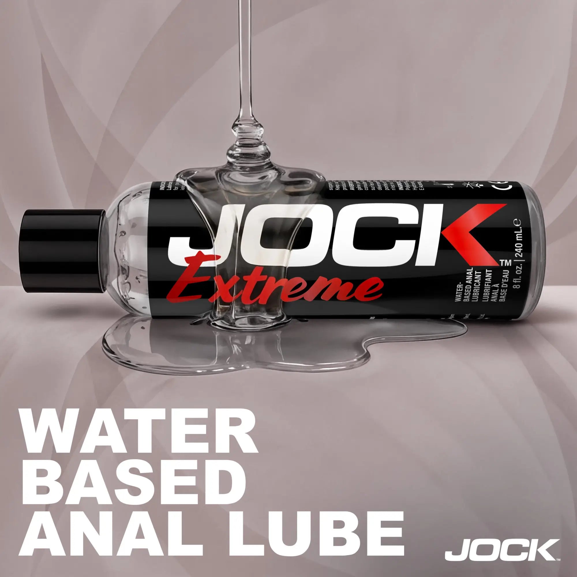 JOCK Extreme anal lubricant 8oz bottle with clear gel dripping onto a black and red label against a gray background.