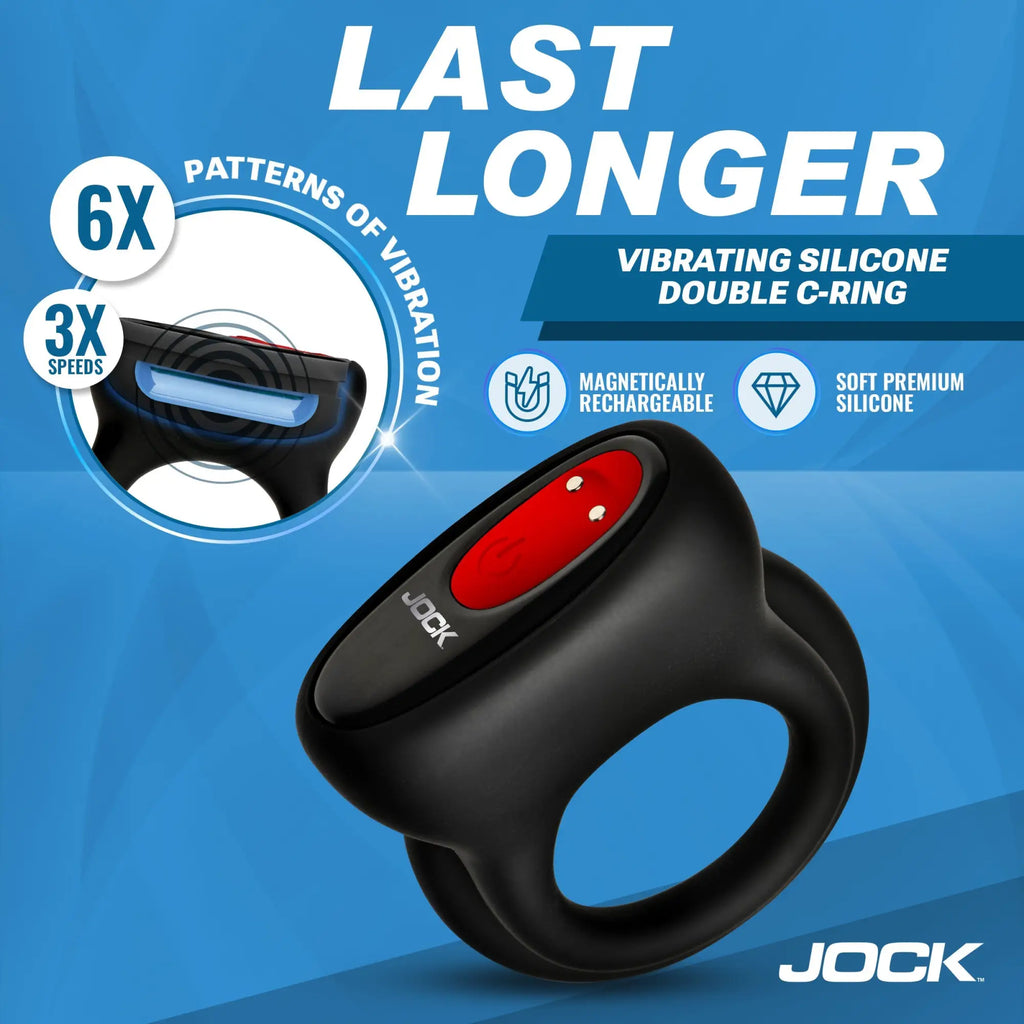 Jock Hard-On black silicone double C-ring with a red power button and magnetic charging port on a blue background.