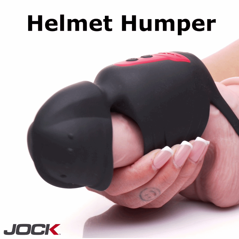 Black silicone Jock Helmet Humper masturbator with red buttons, shown in use against a hand.