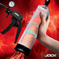 Jock Pump Up Penis Pump, featuring a clear cylinder, black trigger handle with pressure gauge, on a red fiery background.